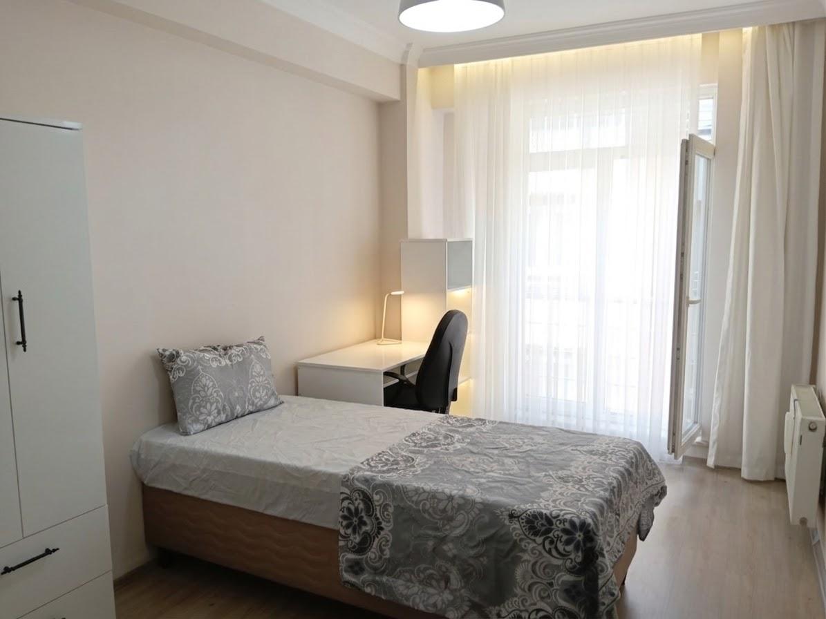 Tek kişilik oda, çalışma masası ve kitaplık